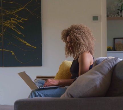 Smiling woman using laptop