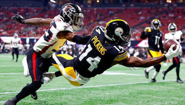 ATLANTA, GEORGIA - AUGUST 24: George Pickens #14 of the Pittsburgh Steelers leaps for a reception over Natrone Brooks #35 of the Atlanta Falcons during the first quarter of a preseason game at Mercedes-Benz Stadium on August 24, 2023 in Atlanta, Georgia. (Photo by